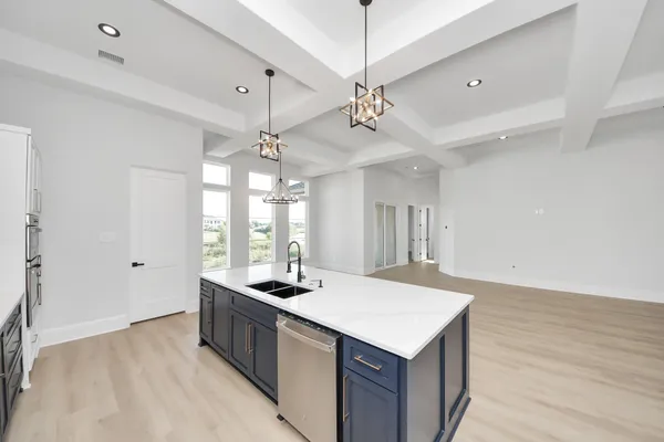 a kitchen with stainless steel appliances a sink stove and cabinets