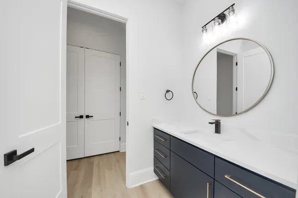 a bathroom with a sink mirror and vanity