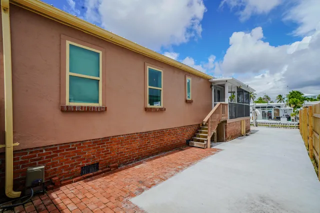 a view of a patio with table and chairs with wooden floor and fence