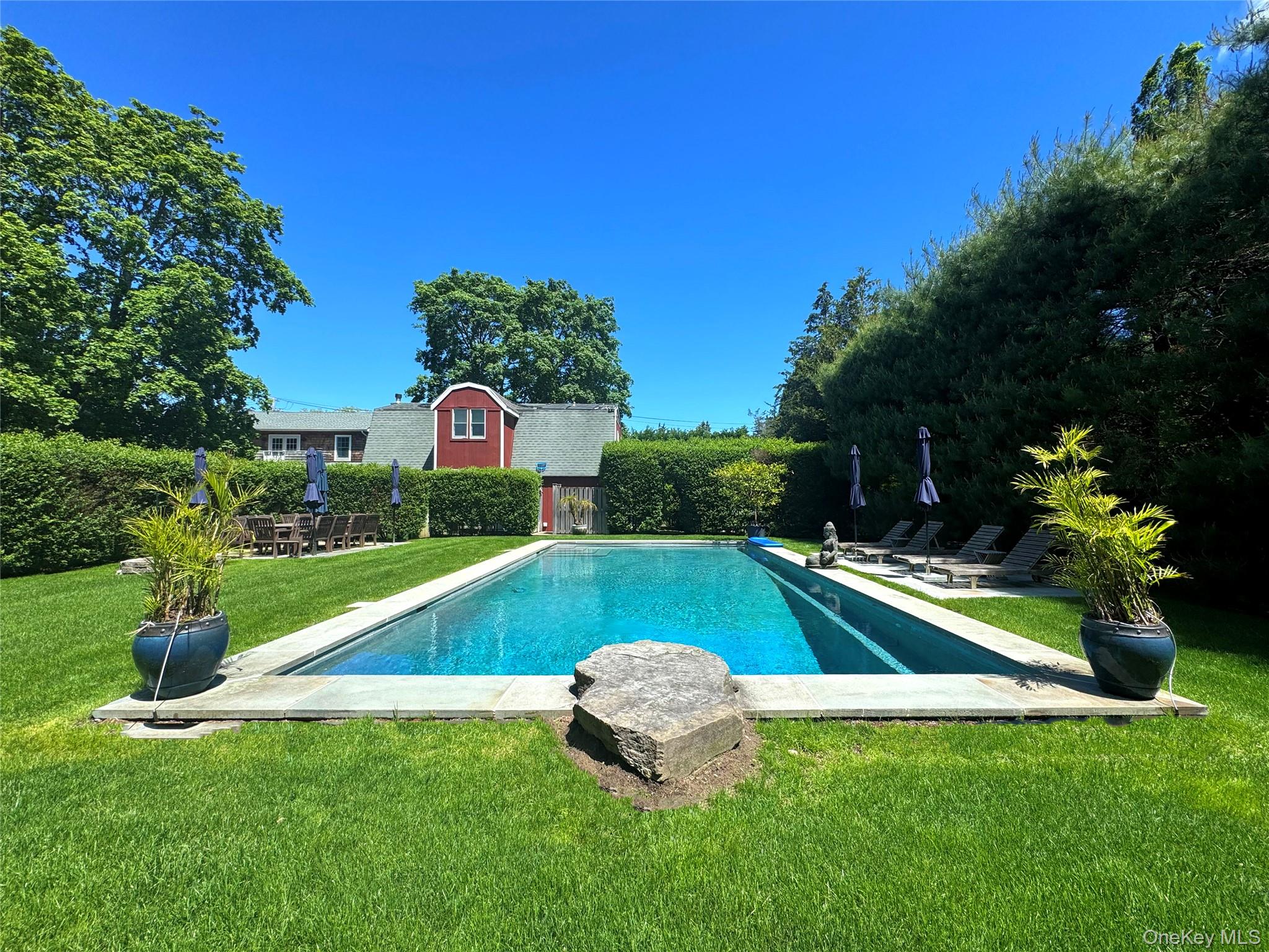 View of pool with a yard and a patio