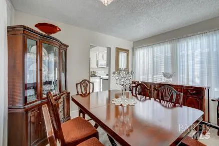 a view of a dining room with furniture and window