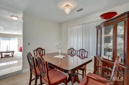 a view of a dining room with furniture window and outside view