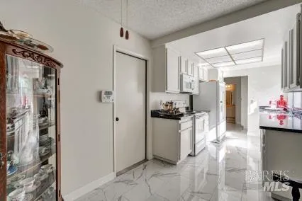 a kitchen with a refrigerator and a sink