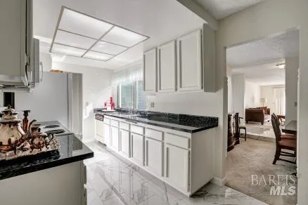 a kitchen with stainless steel appliances granite countertop a stove and a sink