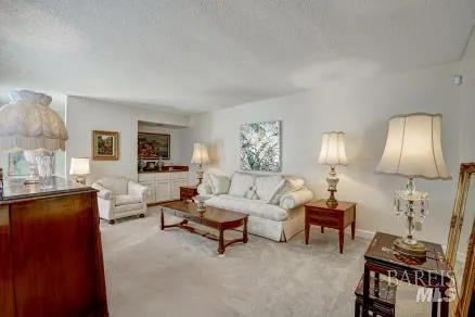a living room with furniture and a lamp