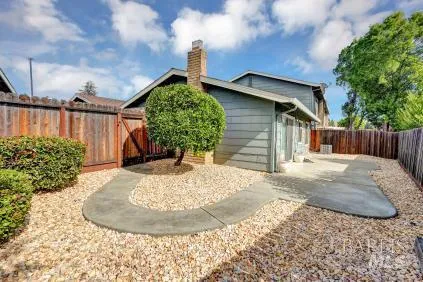 a view of a house with a small yard and plants