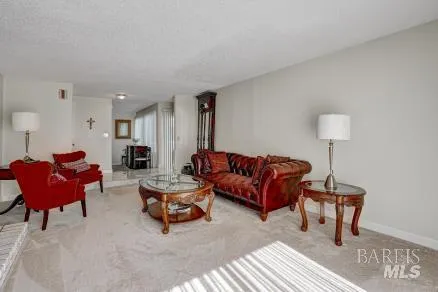 a living room with furniture a red lamp and a window