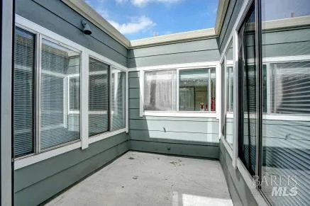 a view of small space with wooden floor and a window