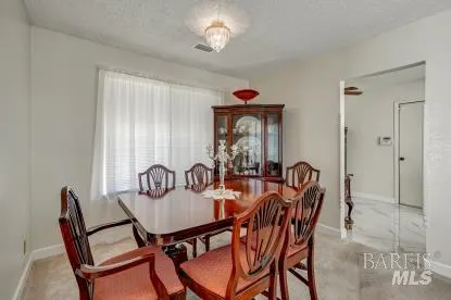 a dining room with furniture and window