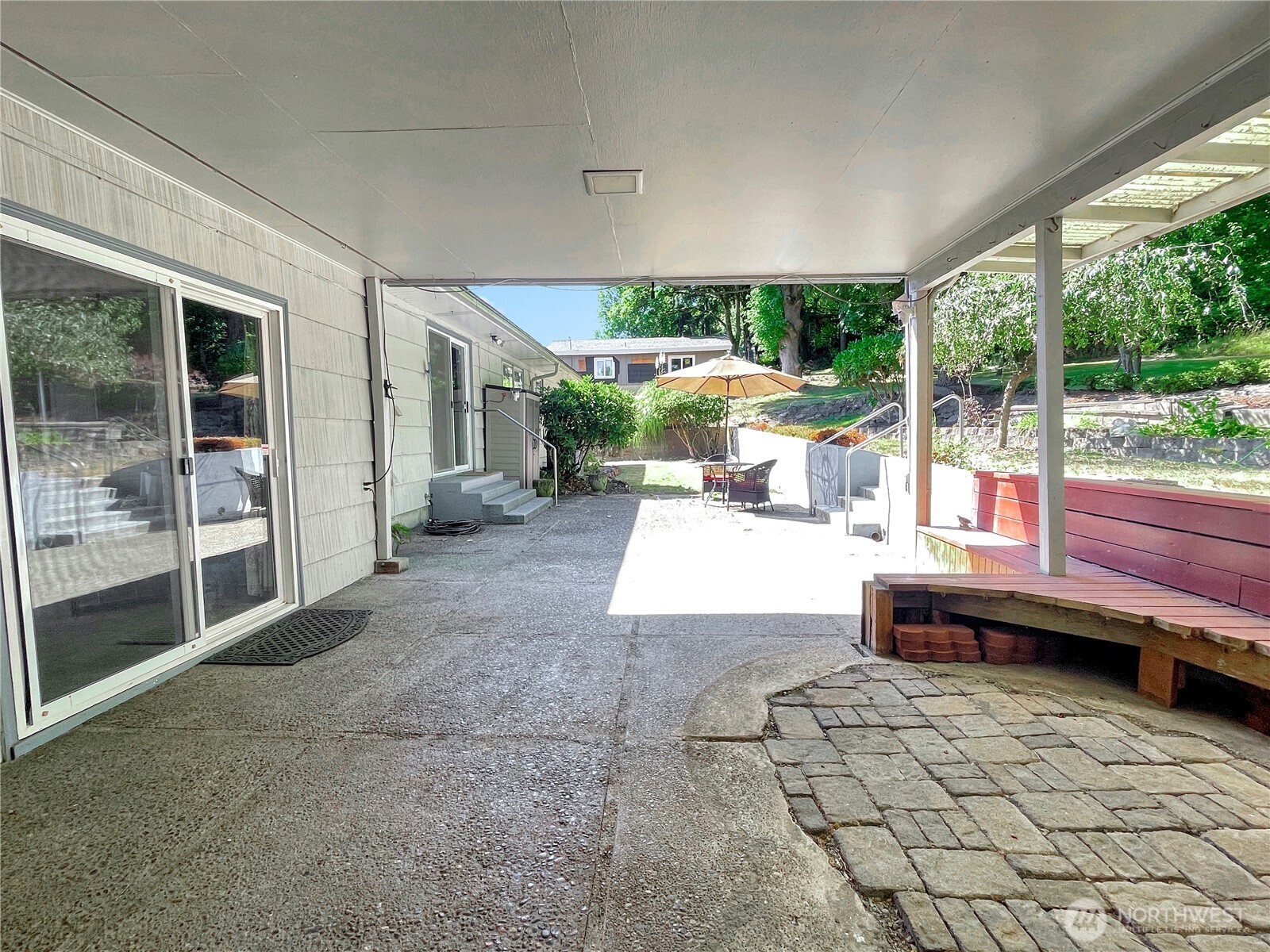 2116 Cascade Way Longview, WA 98632 - Photo 18 of 23 a view of a patio with a table chairs and a floor to ceiling window