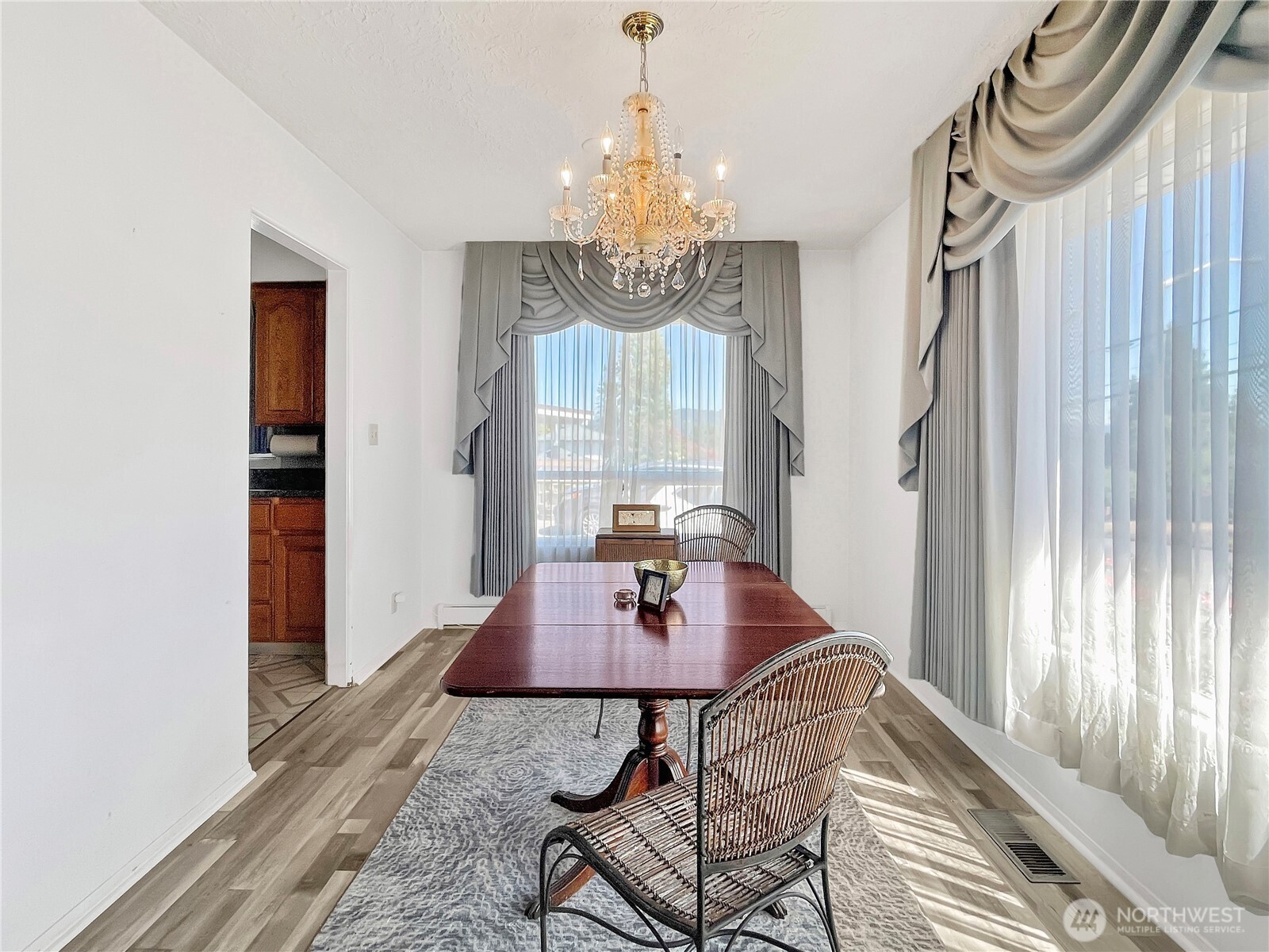 2116 Cascade Way Longview, WA 98632 - Photo 5 of 23 a dining room with chandelier and wooden floor