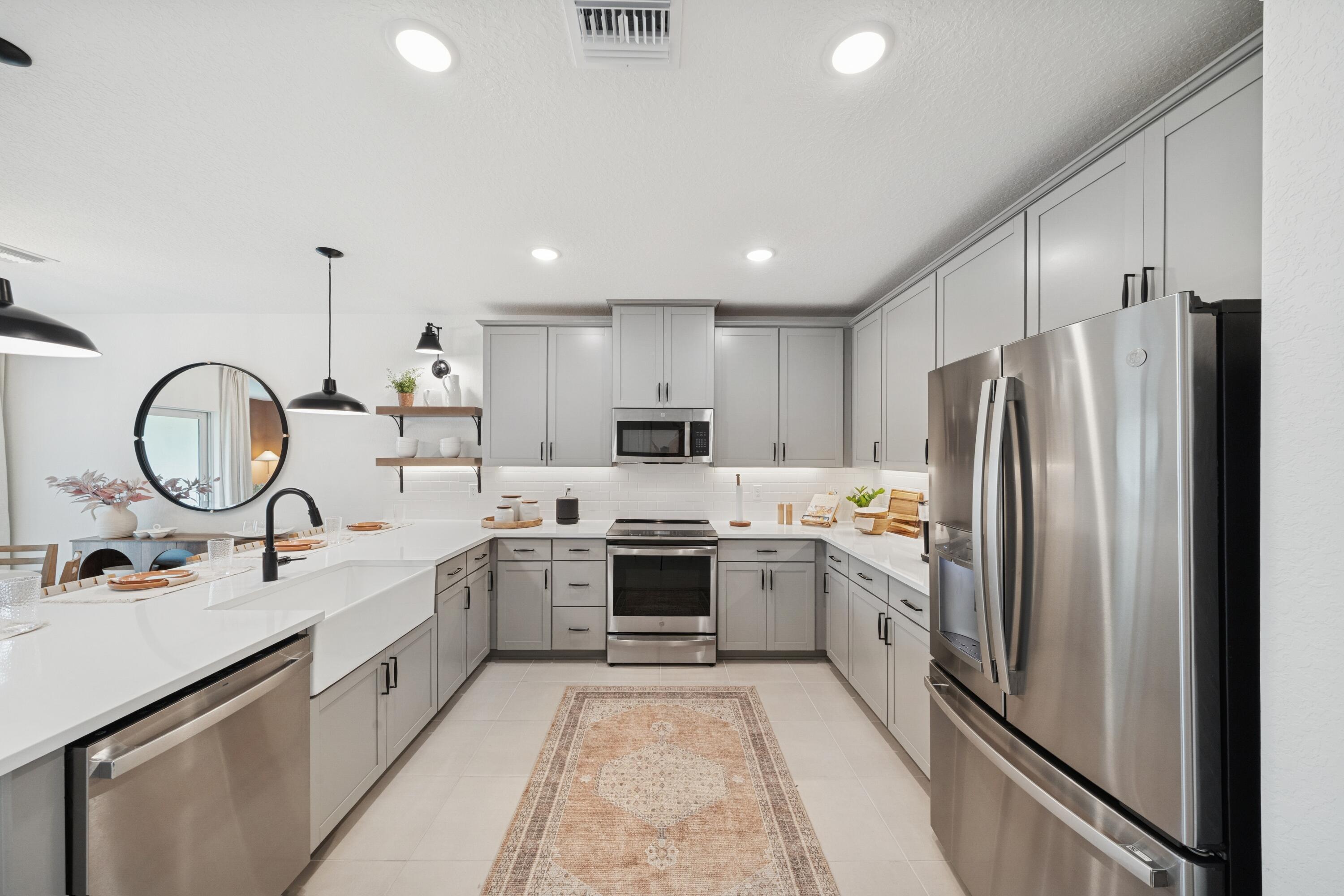 9728 Apollo Avenue, Unit 5 Fort Pierce, FL 34945 - Photo 14 of 39 a large kitchen with kitchen island a sink stainless steel appliances and cabinets