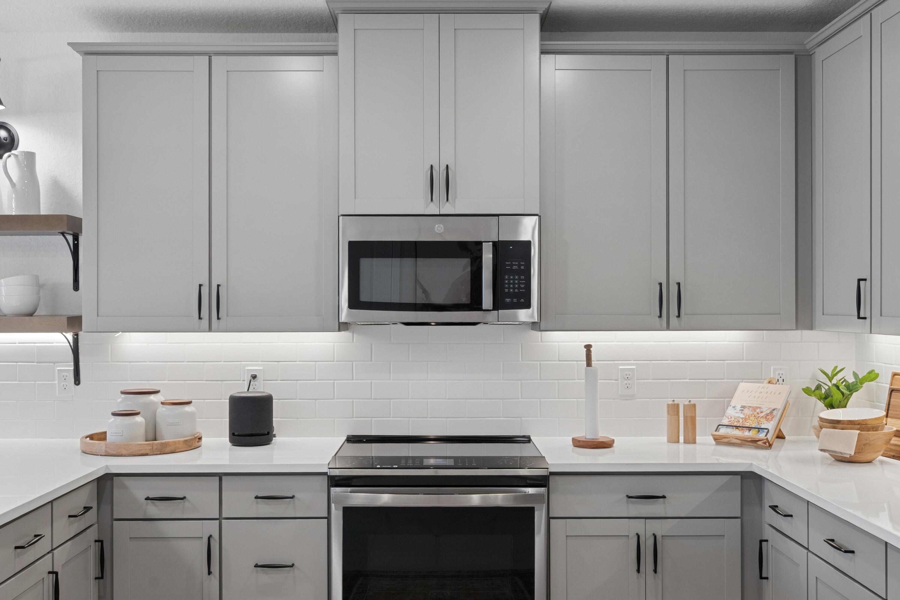 9728 Apollo Avenue, Unit 5 Fort Pierce, FL 34945 - Photo 17 of 39 a kitchen with cabinets stainless steel appliances and a sink