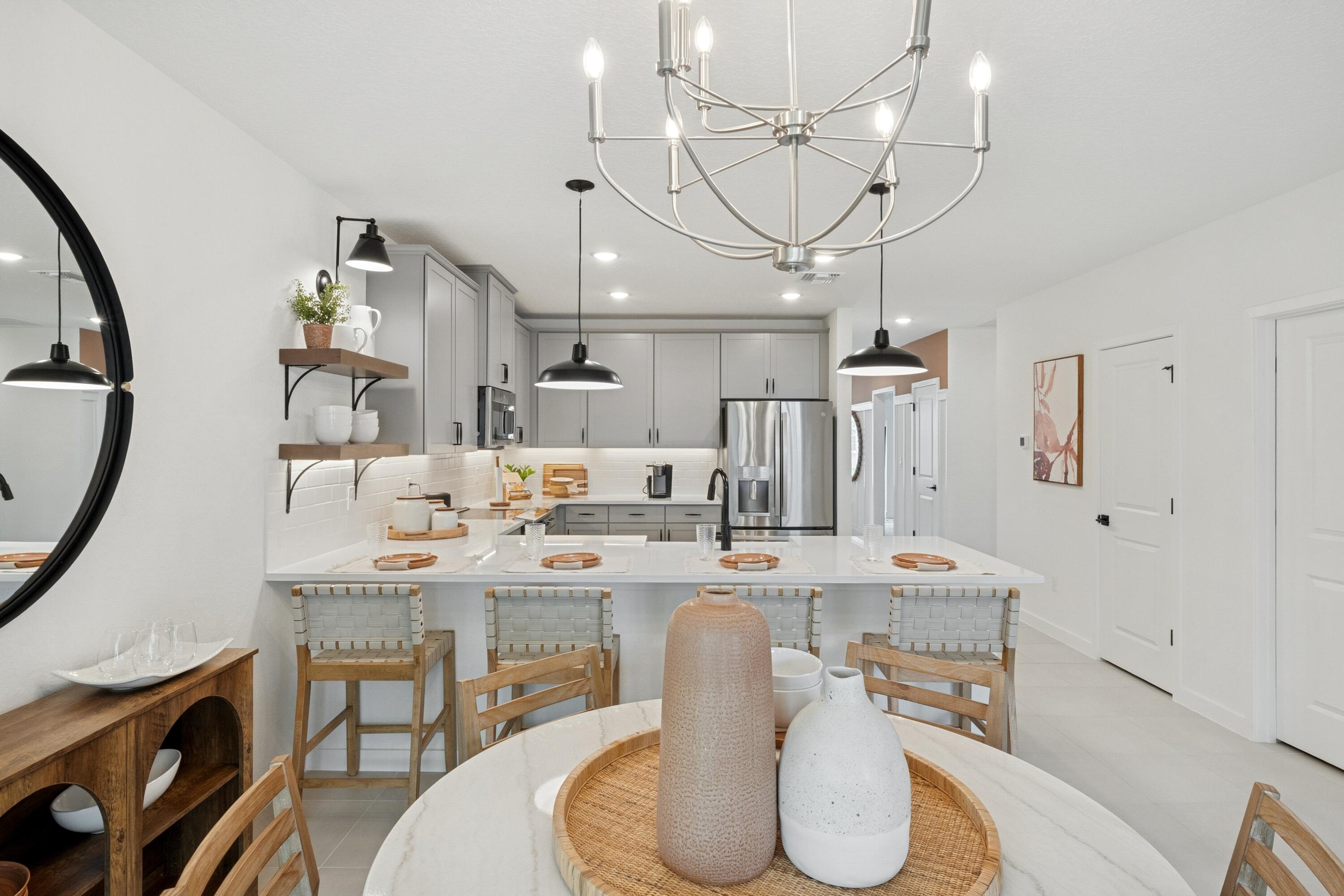 9728 Apollo Avenue, Unit 5 Fort Pierce, FL 34945 - Photo 20 of 39 a dining room with furniture a chandelier and wooden floor