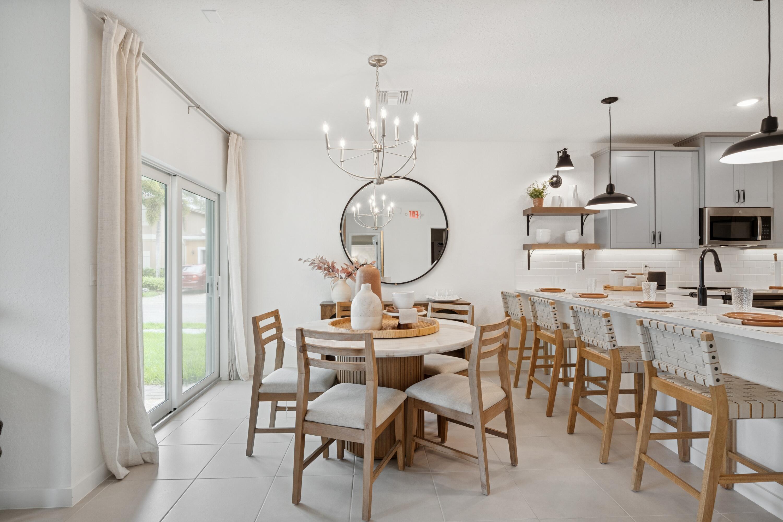 9728 Apollo Avenue, Unit 5 Fort Pierce, FL 34945 - Photo 21 of 39 a view of a dining room with furniture a chandelier and wooden floor