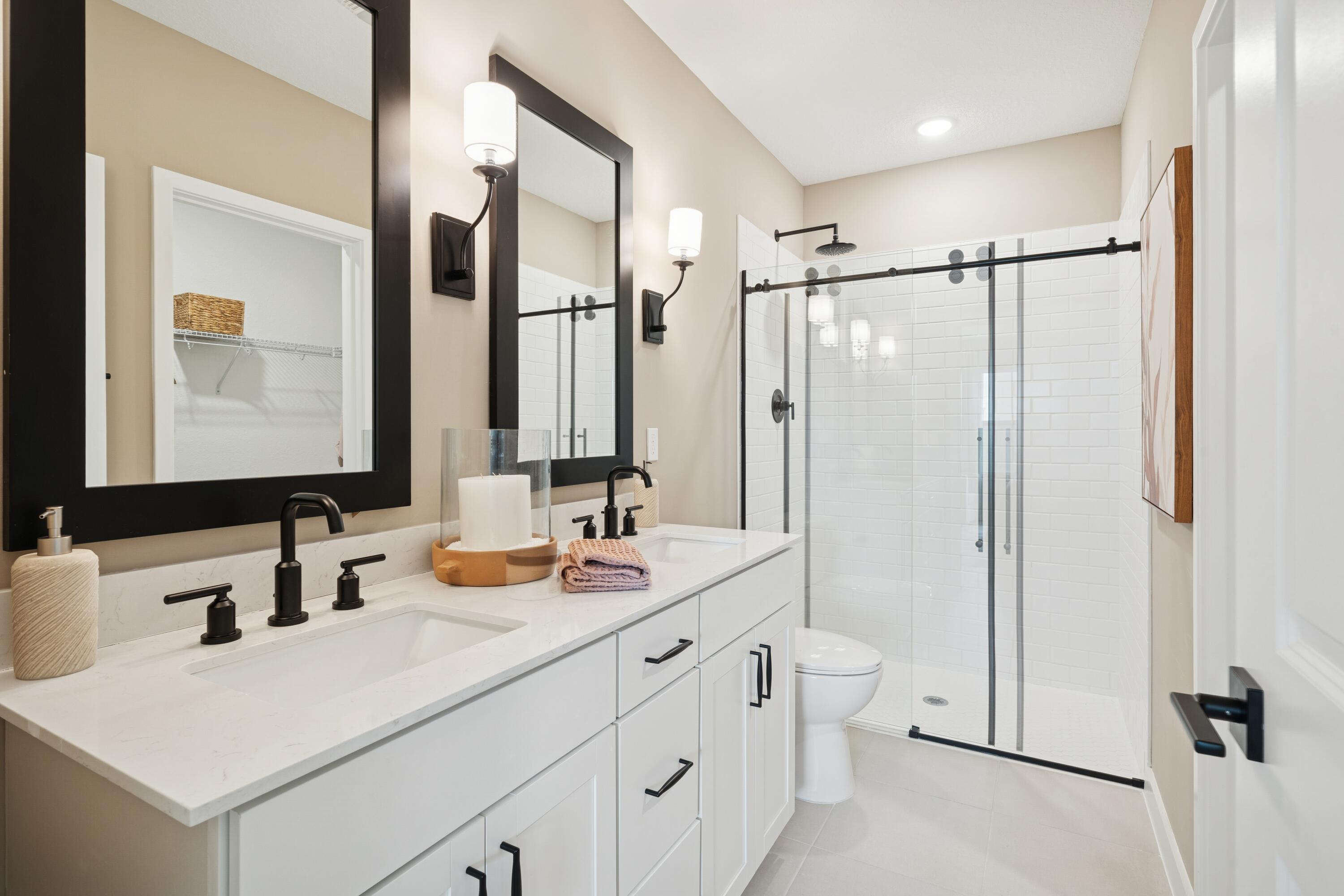 9728 Apollo Avenue, Unit 5 Fort Pierce, FL 34945 - Photo 35 of 39 a bathroom with a double vanity sink mirror and shower
