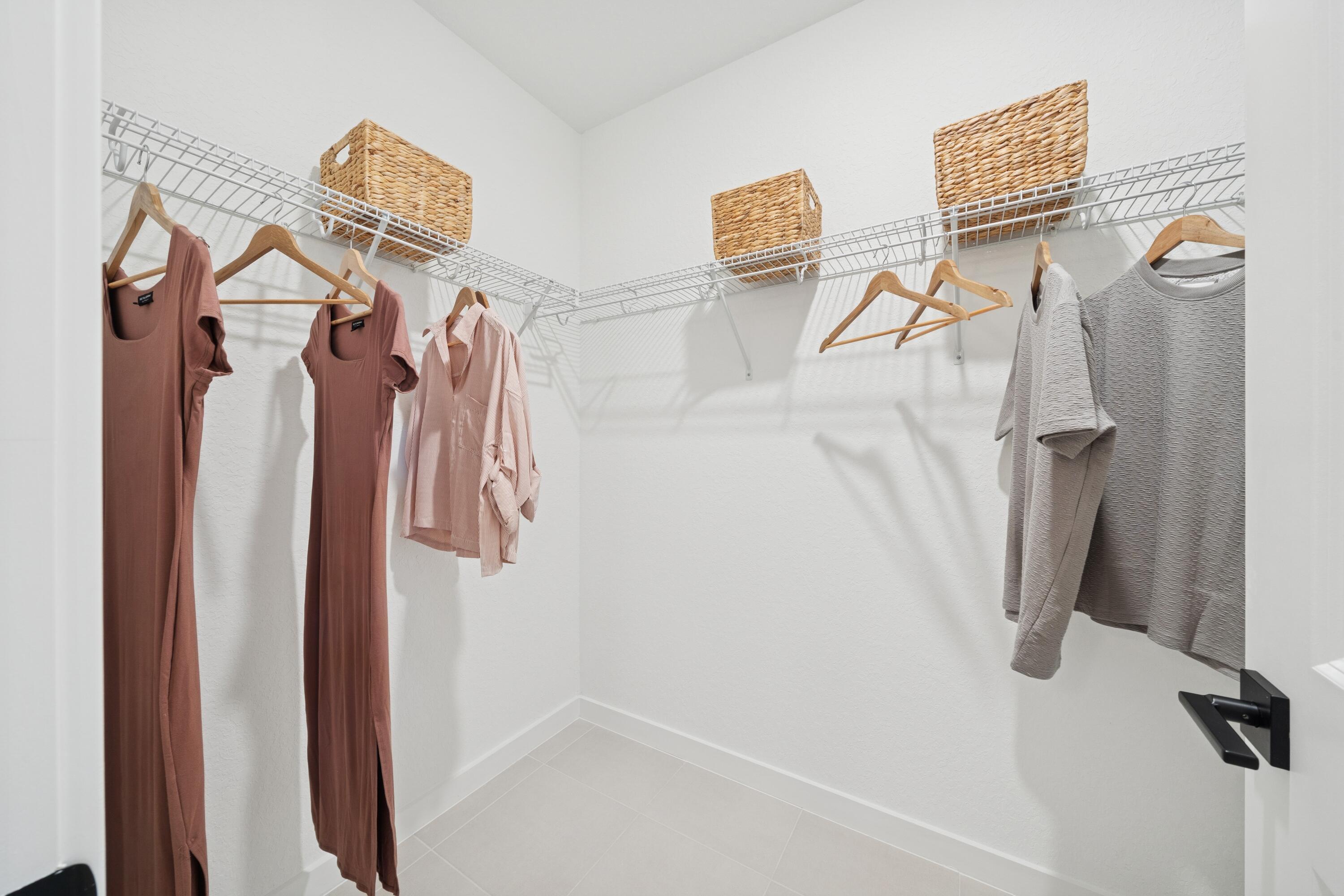 9728 Apollo Avenue, Unit 5 Fort Pierce, FL 34945 - Photo 36 of 39 a view of walk in closet with clothes and shoes