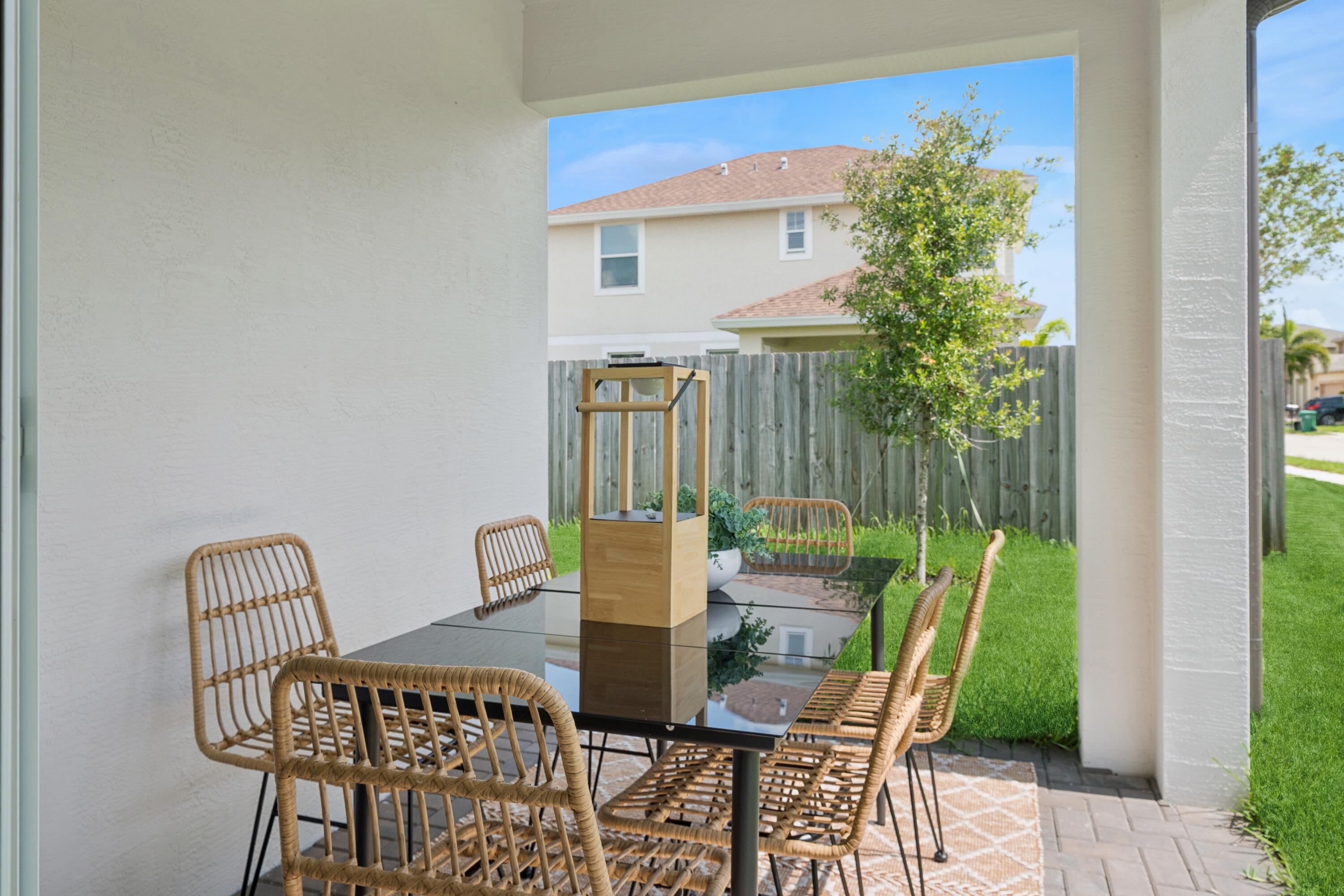 9728 Apollo Avenue, Unit 5 Fort Pierce, FL 34945 - Photo 37 of 39 a view of a chairs and table in patio