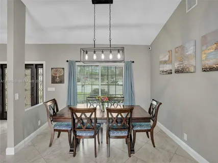 a dining room with furniture and window