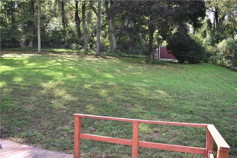 691 Bucktown Road Irwin, PA 15642 - Photo 22 of 23 Yard goes beyond fence. Shed located behind fence is on property and stays.