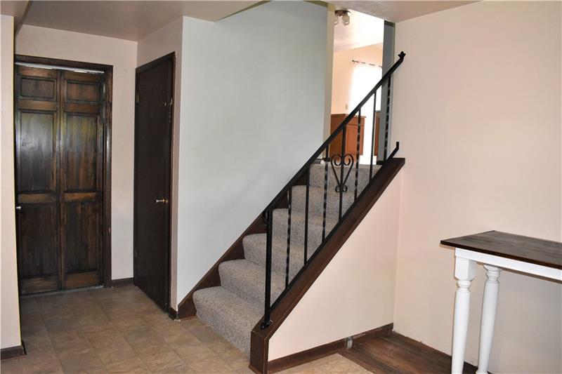 691 Bucktown Road Irwin, PA 15642 - Photo 4 of 23 Family Room located off left of entry. Straight ahead to Laundry. Door to Right leads to Garage. Stairs lead to Living Room.