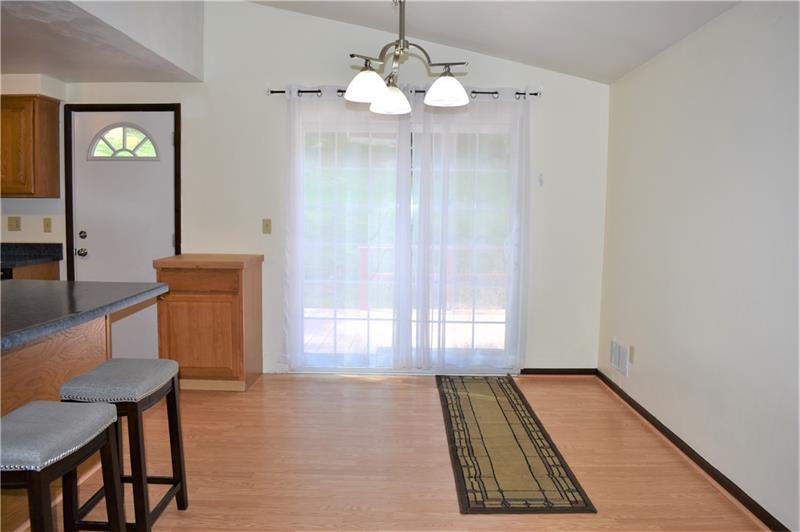 691 Bucktown Road Irwin, PA 15642 - Photo 8 of 23 Dining room w/vaulted ceiling is 13x9. Sliding glass doors lead to back porch and fenced yard.