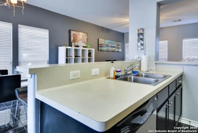 a kitchen with a sink and a window