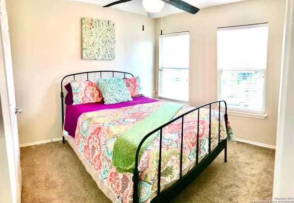 a bedroom with a bed and a painting on the wall