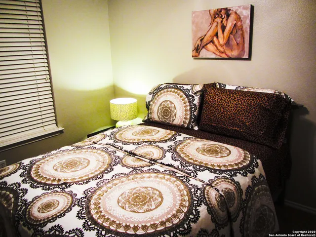a bathroom with a granite countertop sink toilet and a mirror