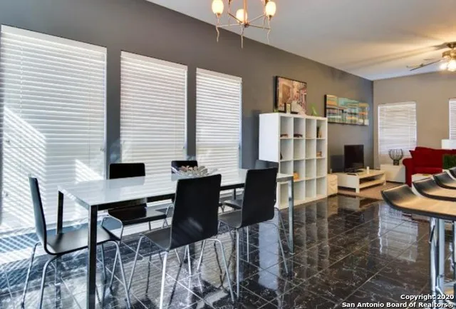 a view of a dining room with furniture and a window