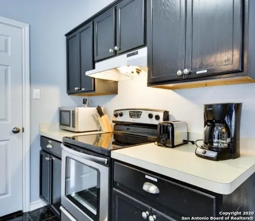 a kitchen with stainless steel appliances granite countertop a sink stove and cabinets