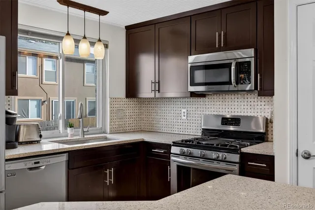 a kitchen with a sink stove and microwave