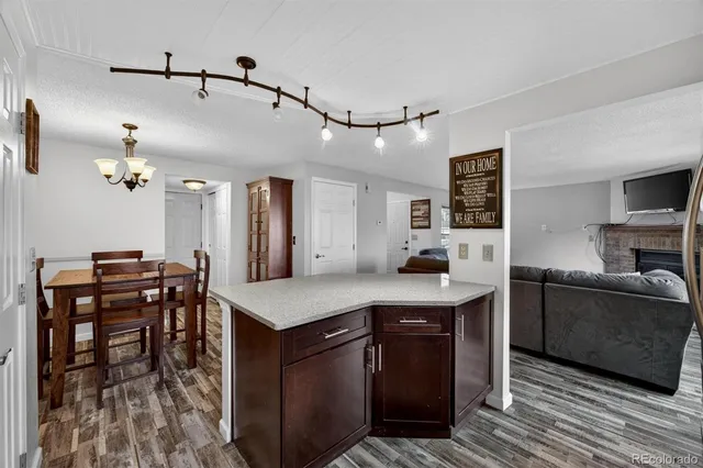 a kitchen with a stove a refrigerator and a dining table