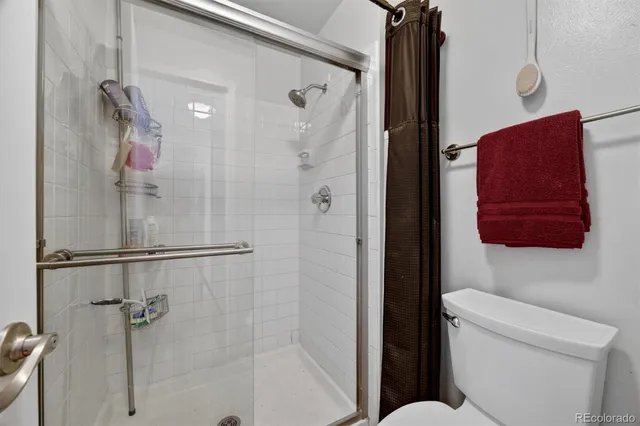 a bathroom with a shower and a toilet
