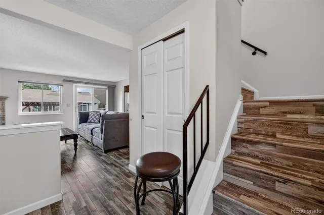 a view of entryway and hall with wooden floor