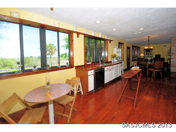 73 Magnolia Avenue St. Augustine, FL 32084 - Photo 9 of 22 a dining hall with stainless steel appliances granite countertop a stove top oven a dining table and chairs with wooden floor