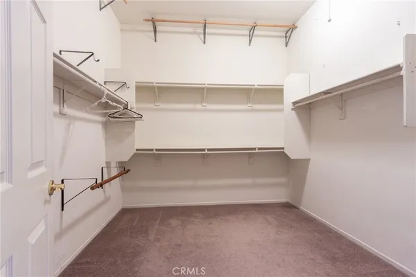 a spacious bathroom with a granite countertop tub a double vanity sink and a mirror