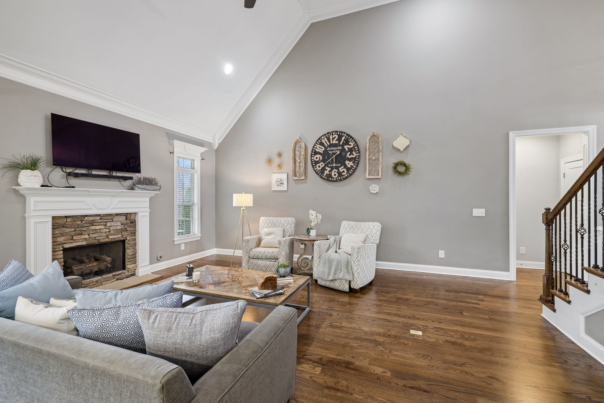 7005 Salmon Run Spring Hill, TN 37174 - Photo 20 of 85 a living room with furniture a flat screen tv and a fireplace