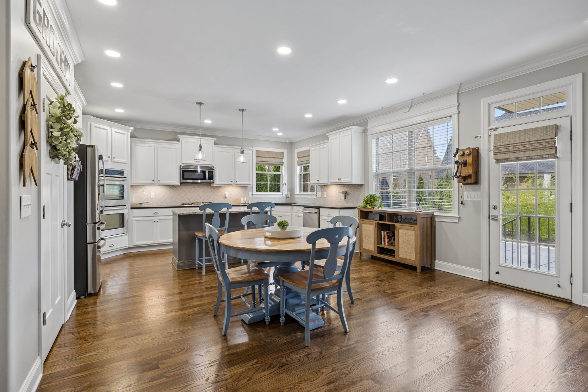 7005 Salmon Run Spring Hill, TN 37174 - Photo 26 of 85 a kitchen with stainless steel appliances kitchen island granite countertop a refrigerator a stove a sink a dining table and chairs