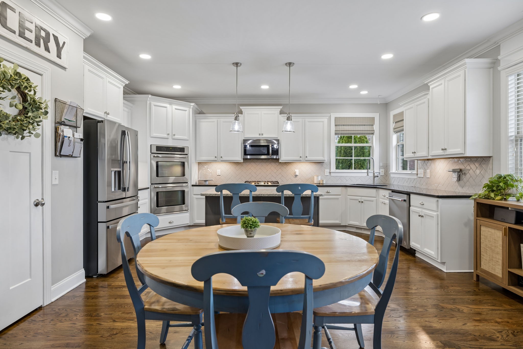 7005 Salmon Run Spring Hill, TN 37174 - Photo 28 of 85 a kitchen with stainless steel appliances granite countertop a dining table chairs refrigerator and microwave
