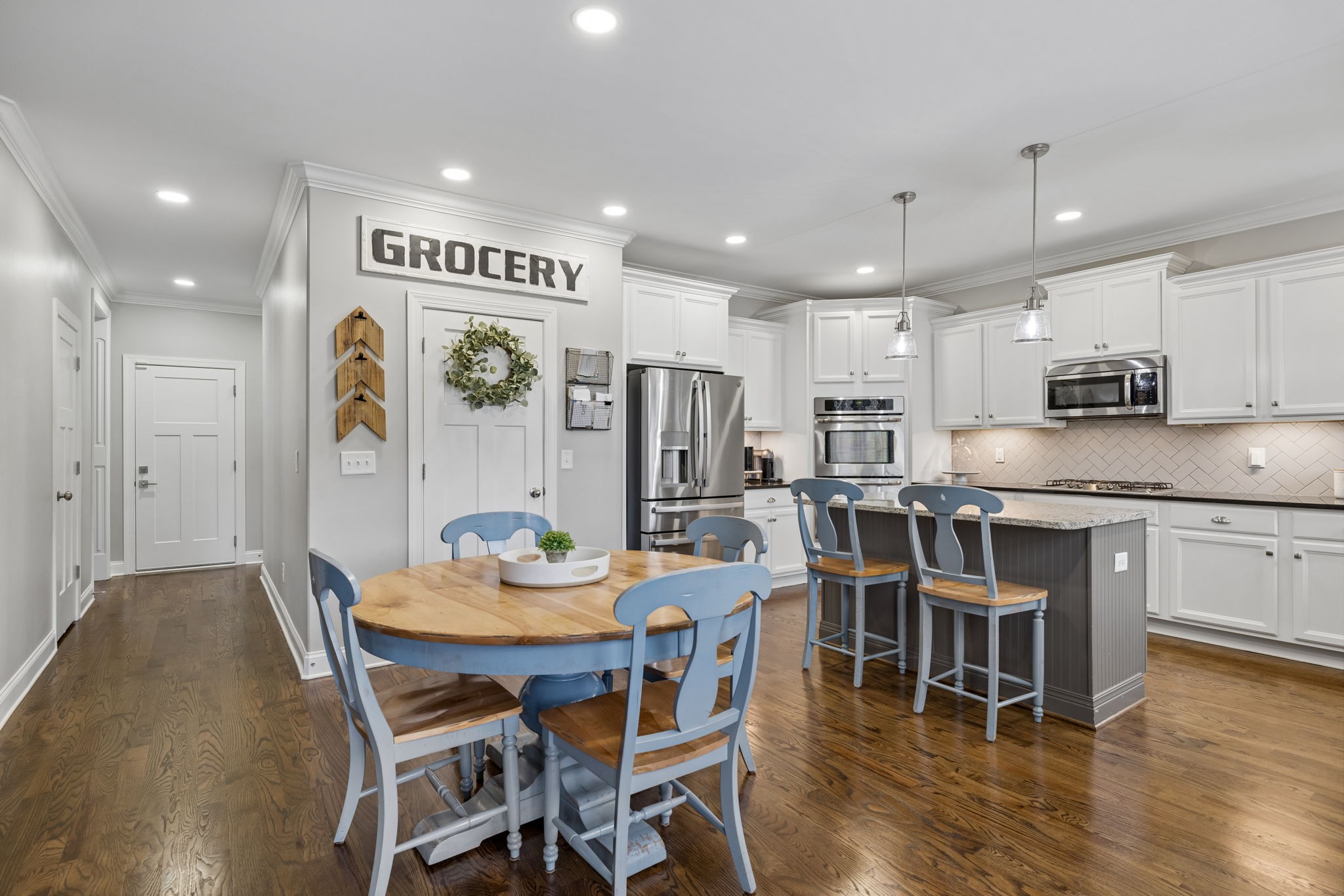7005 Salmon Run Spring Hill, TN 37174 - Photo 30 of 85 a kitchen with stainless steel appliances granite countertop a dining table chairs refrigerator and microwave