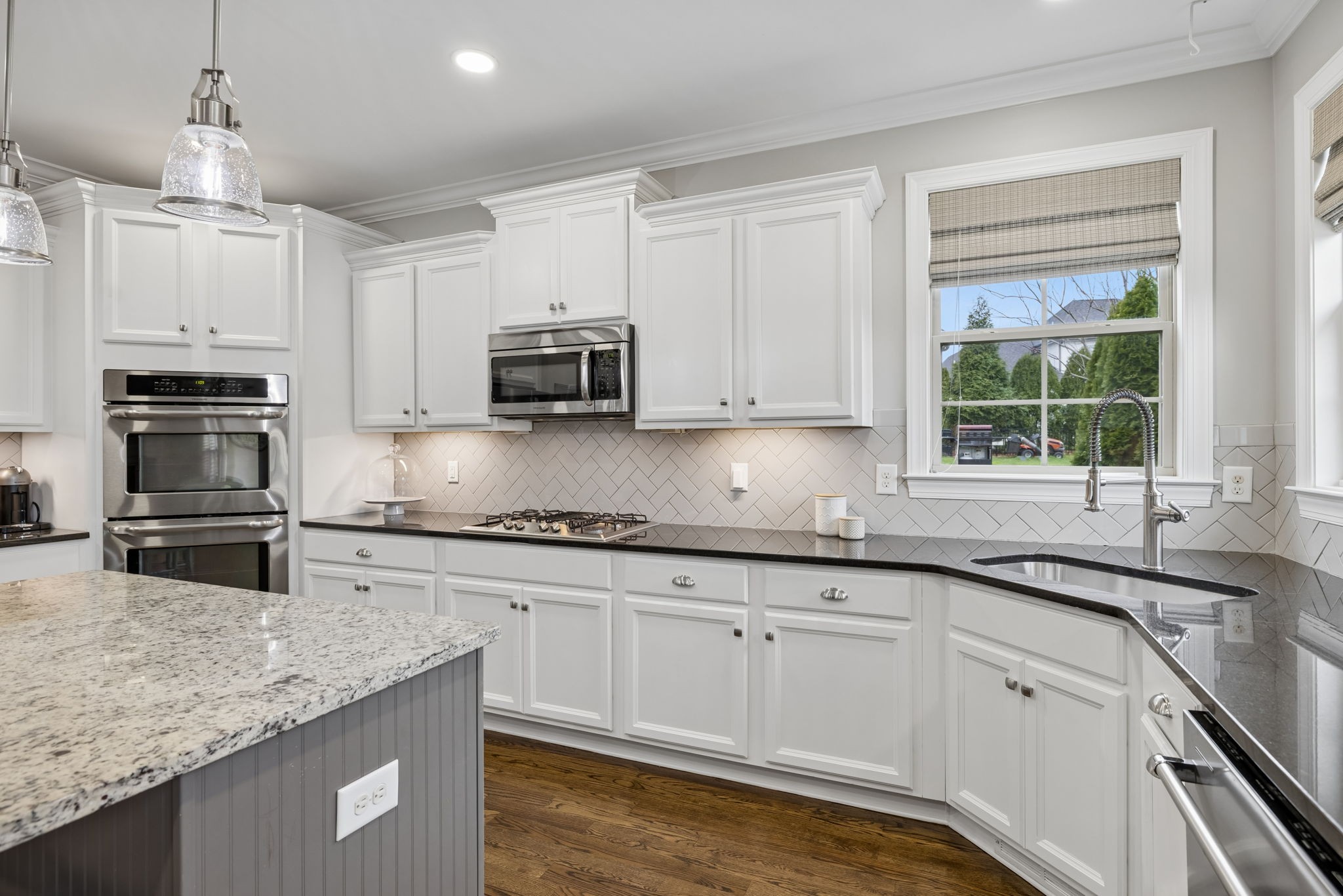 7005 Salmon Run Spring Hill, TN 37174 - Photo 32 of 85 a kitchen with stainless steel appliances granite countertop a sink a stove and cabinets