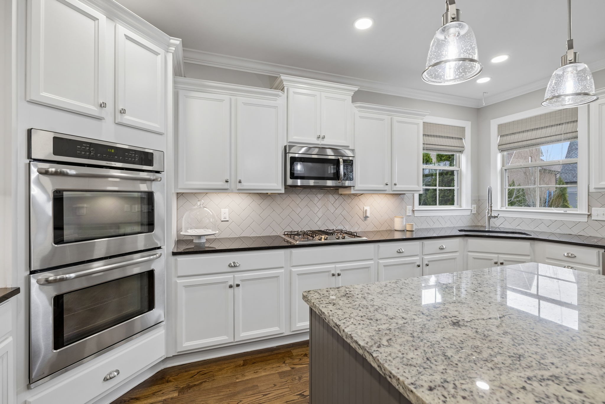 7005 Salmon Run Spring Hill, TN 37174 - Photo 34 of 85 a kitchen with granite countertop a stove sink and microwave