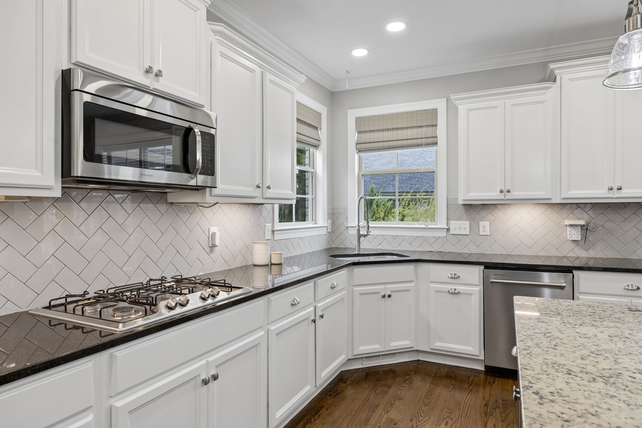 7005 Salmon Run Spring Hill, TN 37174 - Photo 36 of 85 a kitchen with granite countertop a stove a sink and a microwave