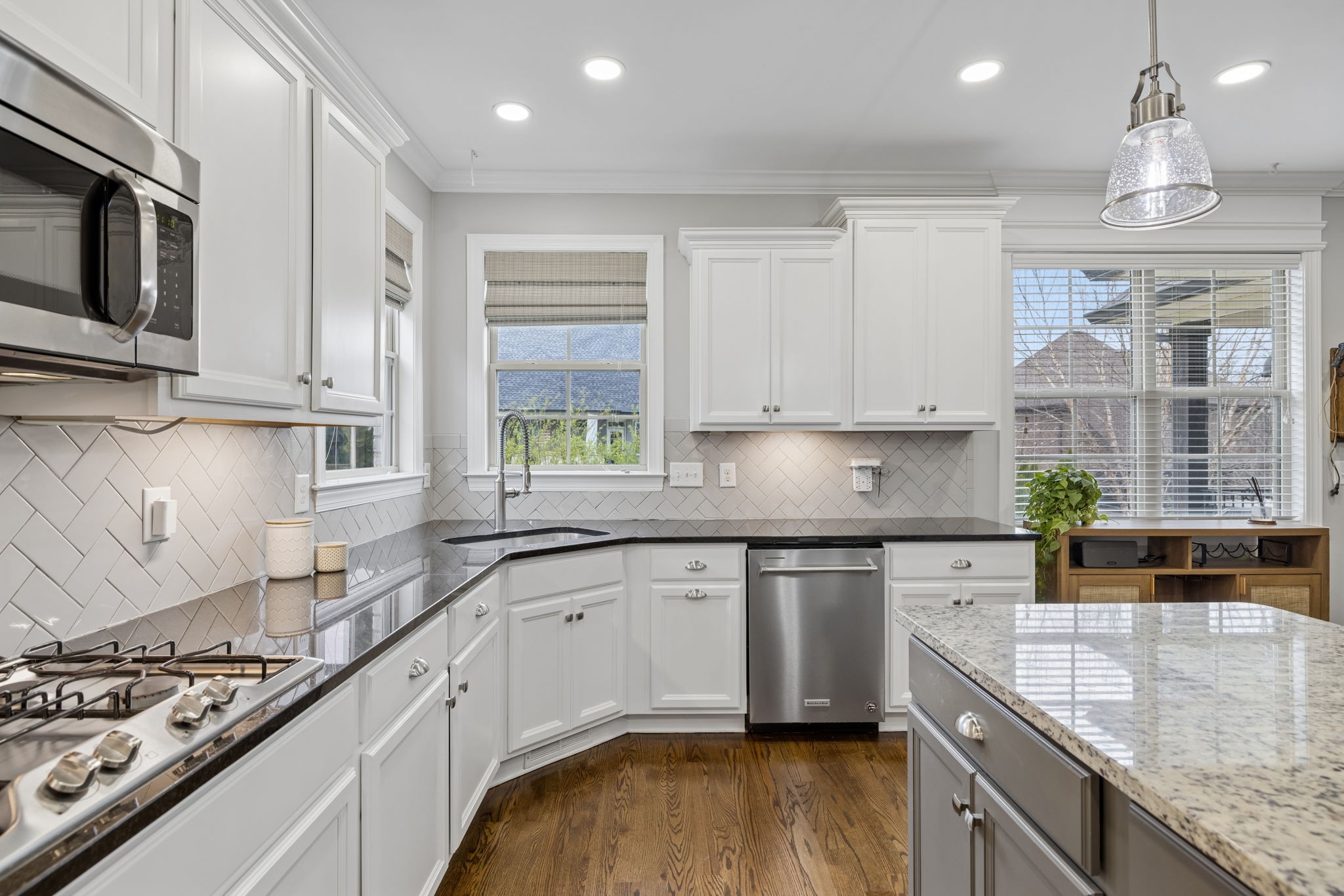 7005 Salmon Run Spring Hill, TN 37174 - Photo 37 of 85 a kitchen with stainless steel appliances granite countertop a stove a sink and a granite counter tops with white cabinets