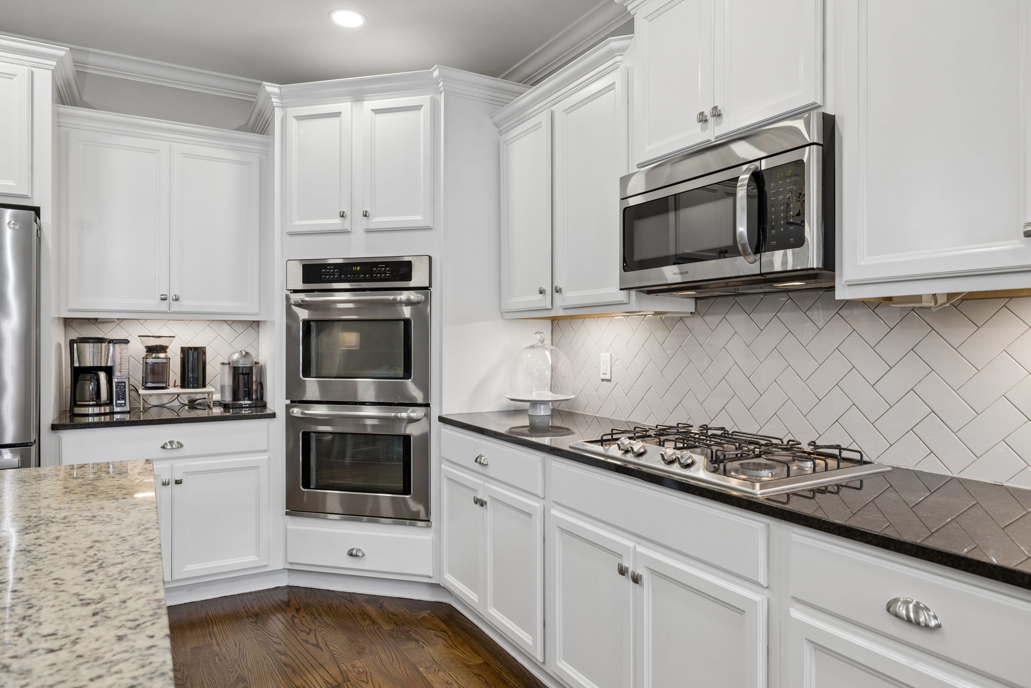 7005 Salmon Run Spring Hill, TN 37174 - Photo 42 of 85 a kitchen with granite countertop white cabinets and stainless steel appliances