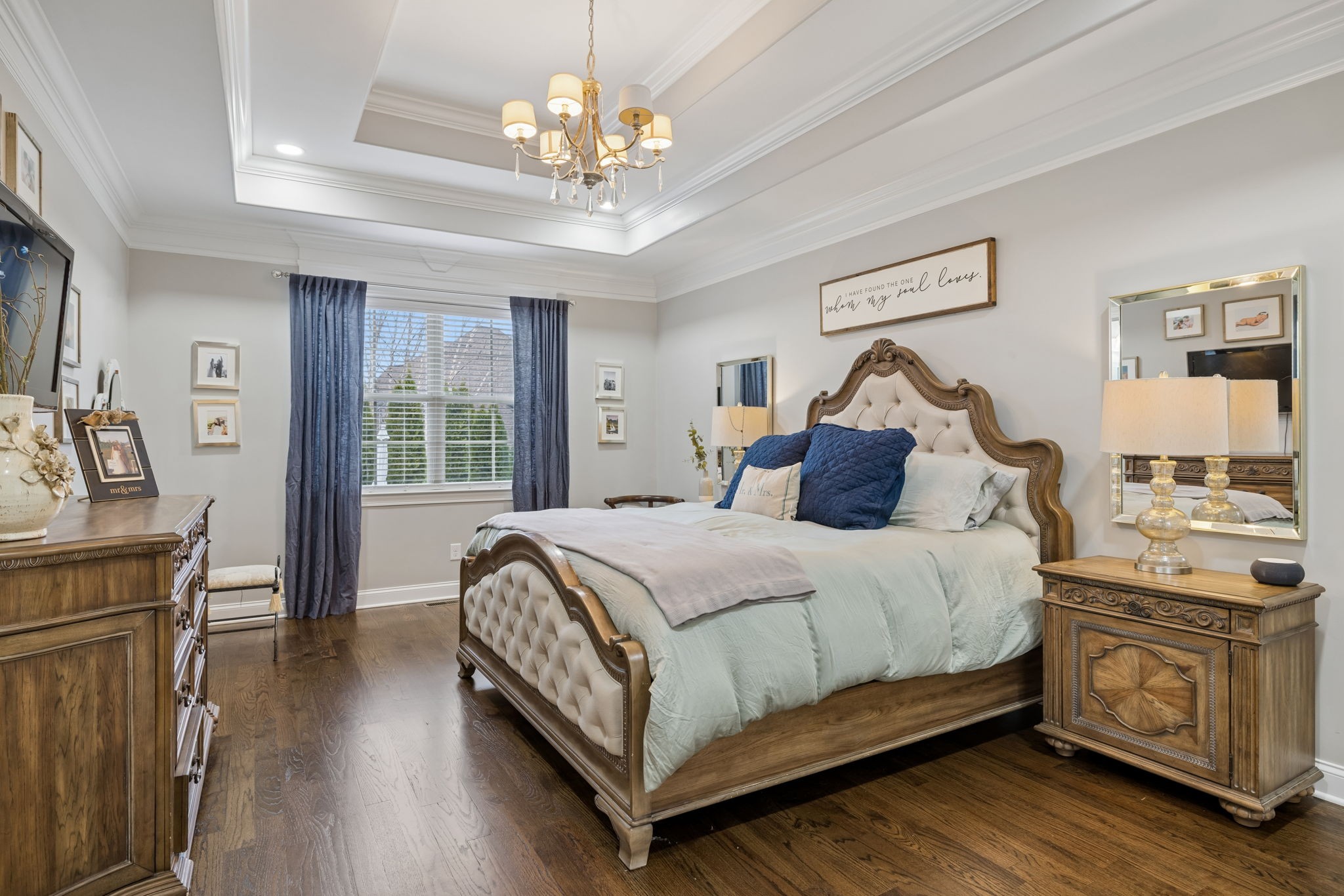 7005 Salmon Run Spring Hill, TN 37174 - Photo 48 of 85 a bedroom with a large bed and a chandelier