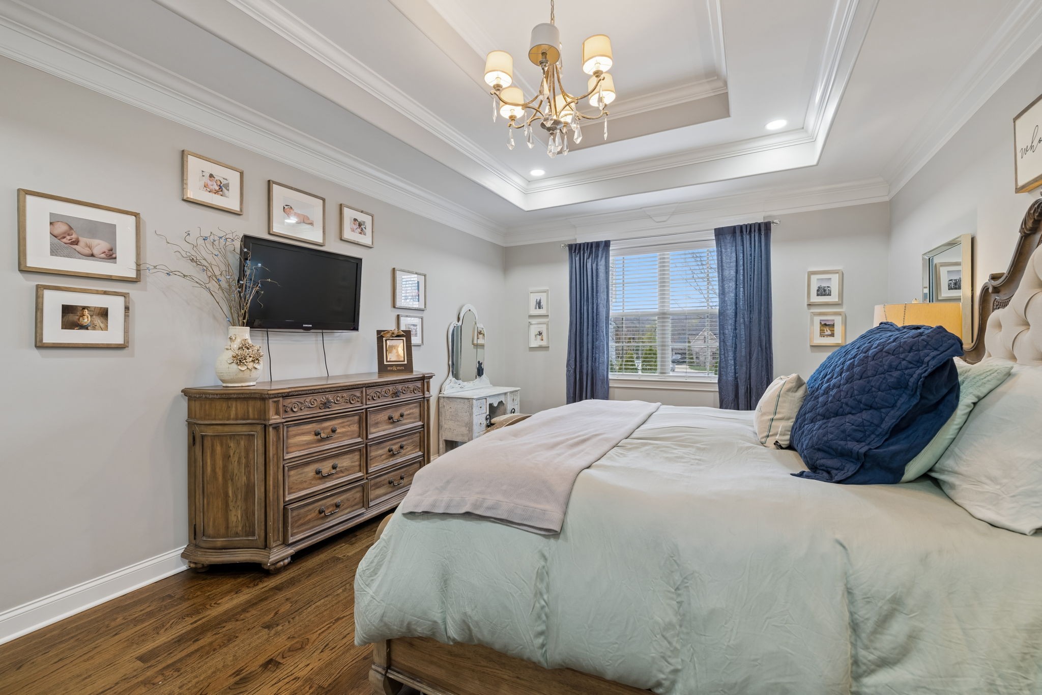 7005 Salmon Run Spring Hill, TN 37174 - Photo 50 of 85 a bedroom with a large bed and a flat tv screen on dresser