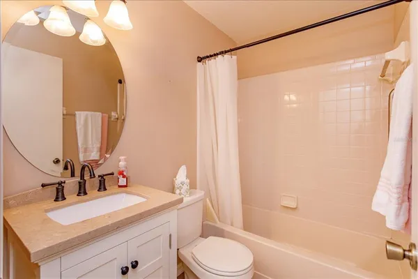 a bathroom with a sink vanity mirror and toilet