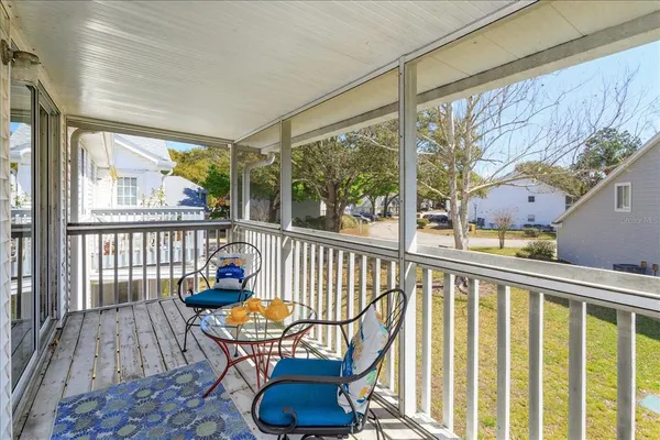 a view of a chair and tables in the balcony